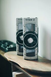 Two Titan Z graphics cards displayed on a wooden desk, showcasing power and design.